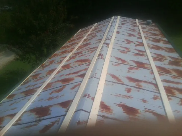 Rusted metal roof panels with new wood purlins before replacement — Storm Damage Roof Repair in Homer City by Roofing Brothers